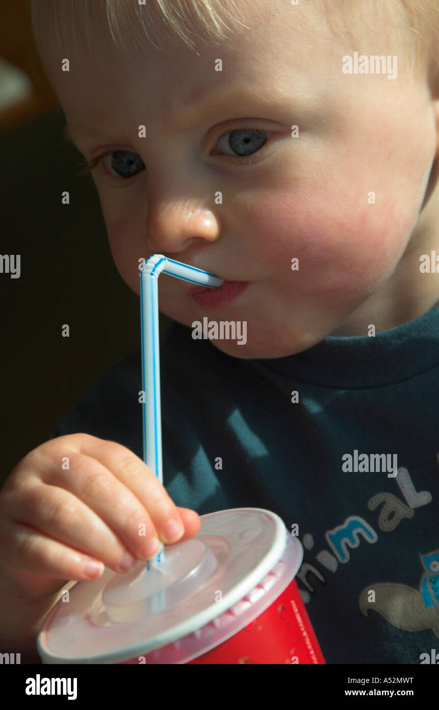 toddler drinking through straw Stock Photo Alamy