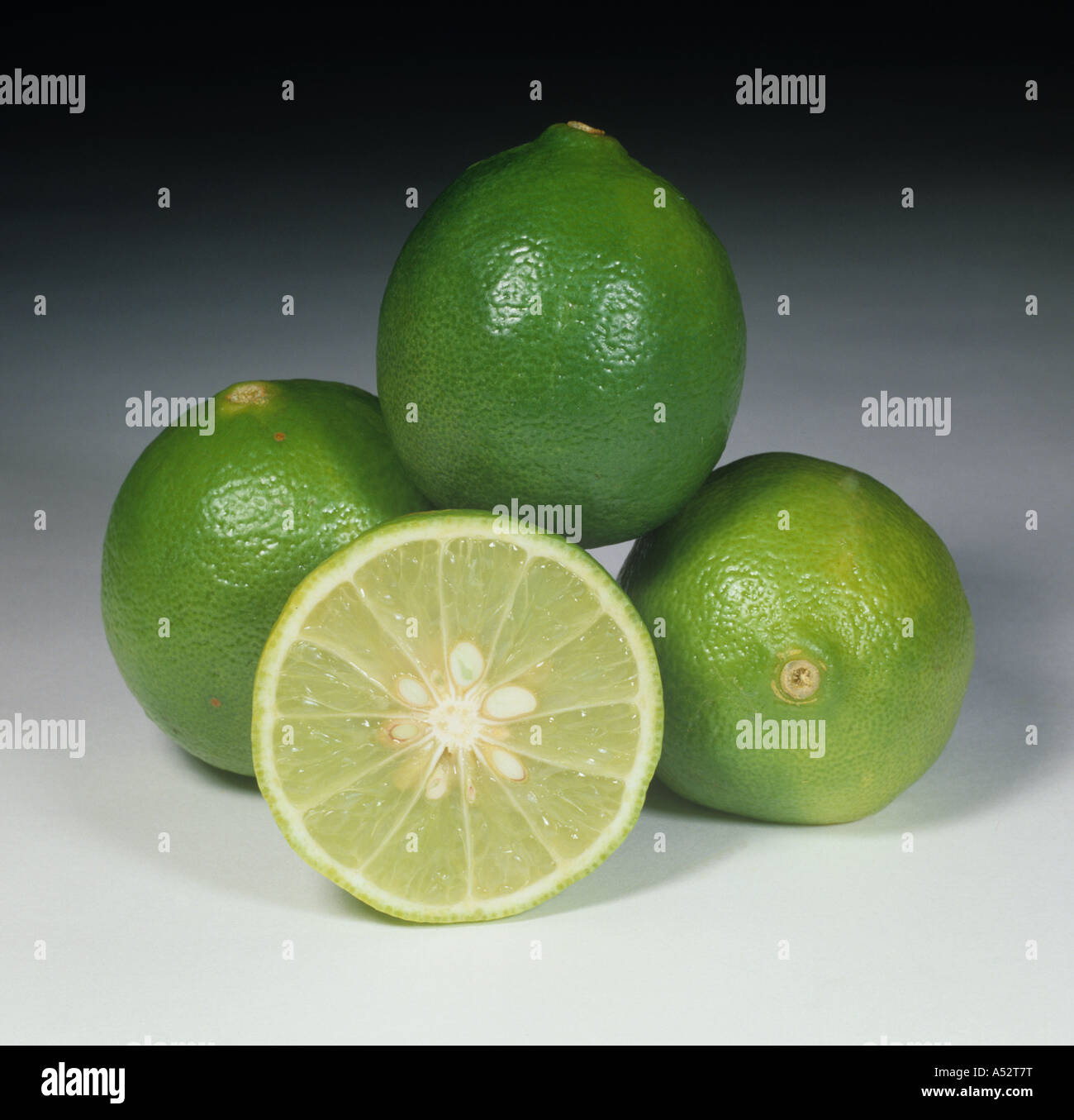 Whole sectioned lime fruit variety West Indian green Stock Photo