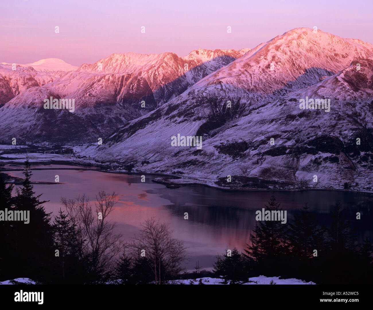MOUNTAINS and LOCH DUICH at DUSK with pink sunlight on snow from Ratagan Pass Highland Scotland UK Stock Photo