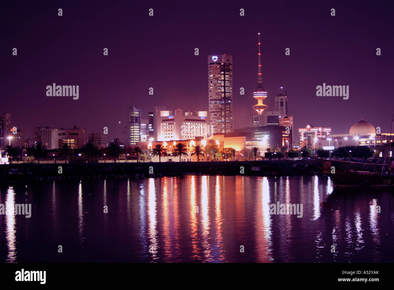 Kuwait city skyline at night by fishing harbor Stock Photo Alamy
