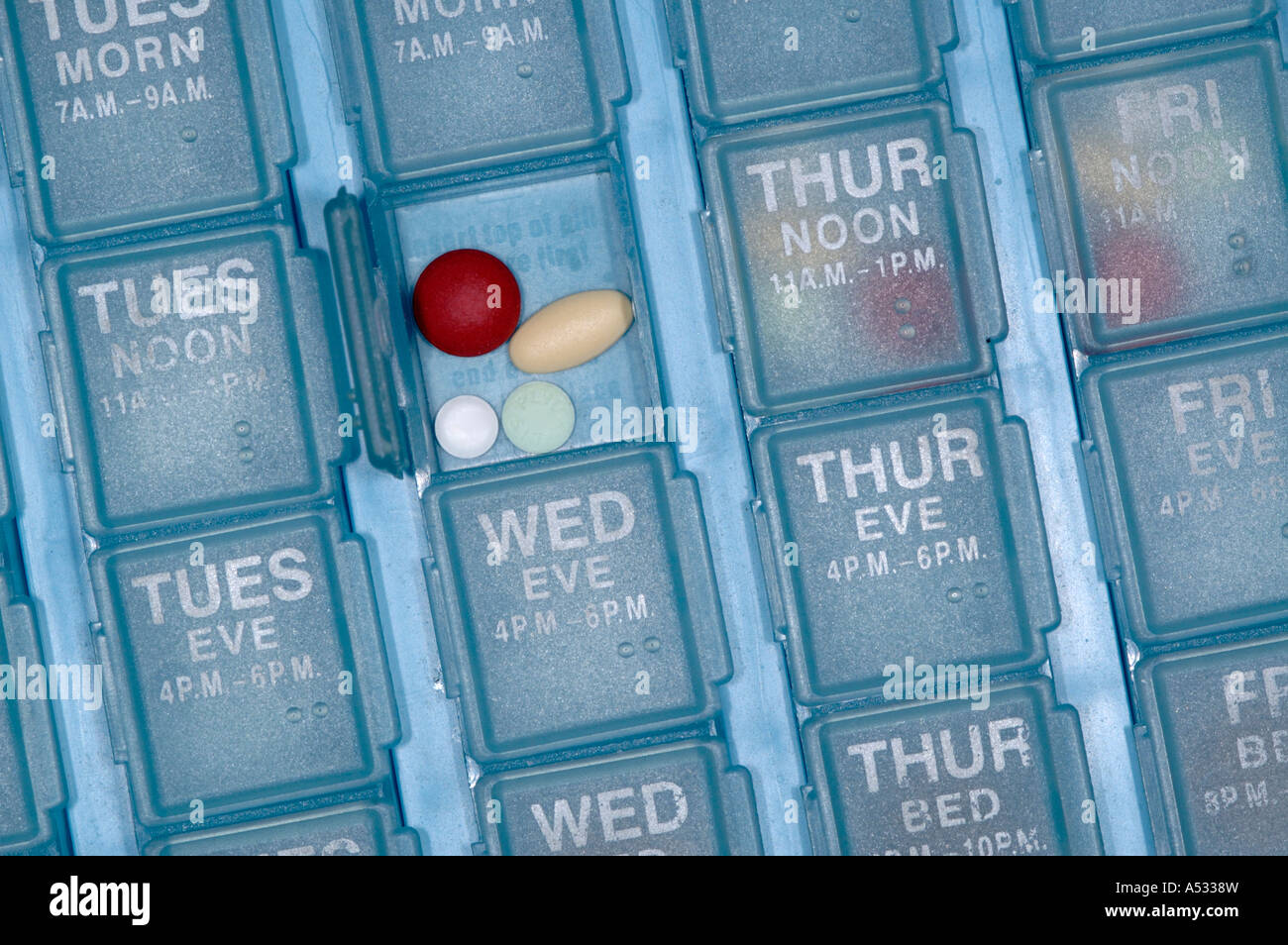 An elderly senior citizen person's daily weekly pill organizer Stock Photo