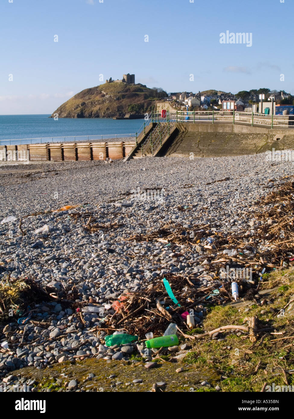 Flotsam and jetsam rubbish on a beach littered with plastic bottles