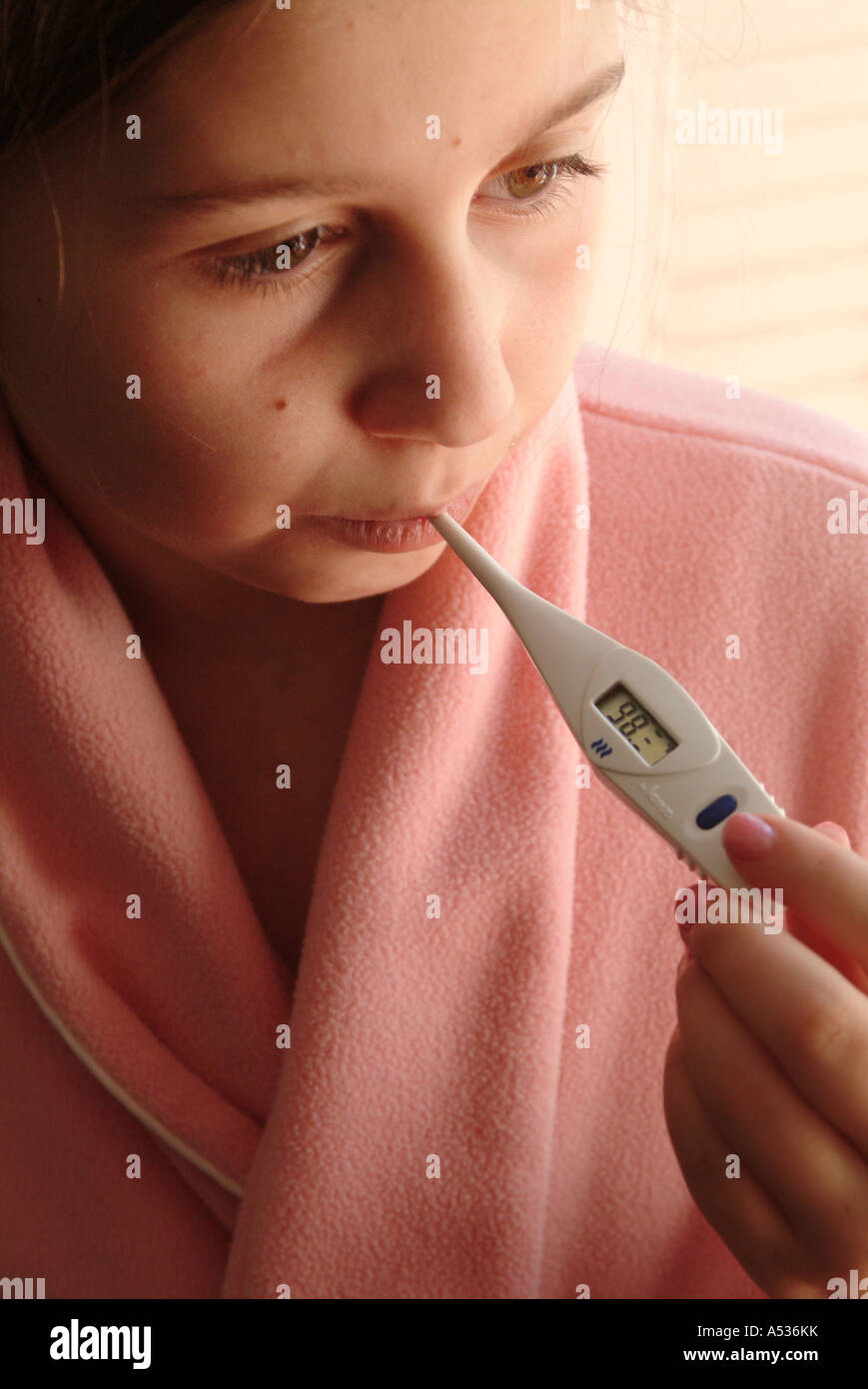 The child has a normal temperature with the thermometer reading 98
