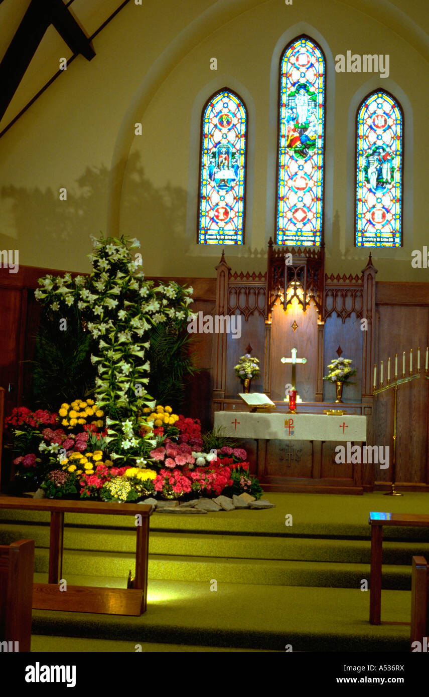 Easter lily cross at church alter celebrating Easter. Minneapolis Minnesota USA Stock Photo