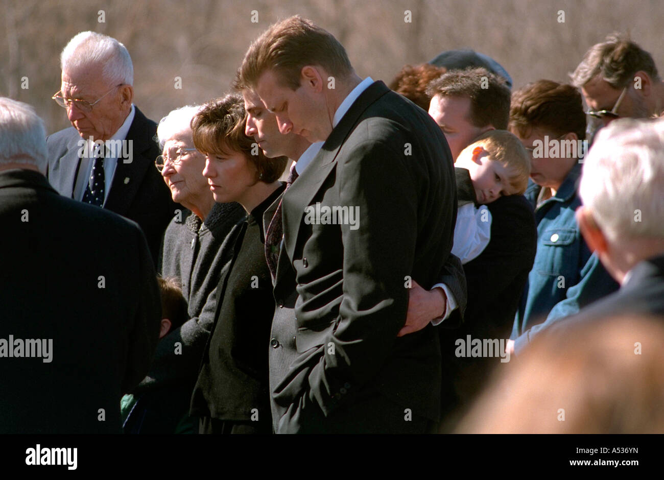Family mourning at cemetery interment. Buffalo Minnesota USA Stock Photo