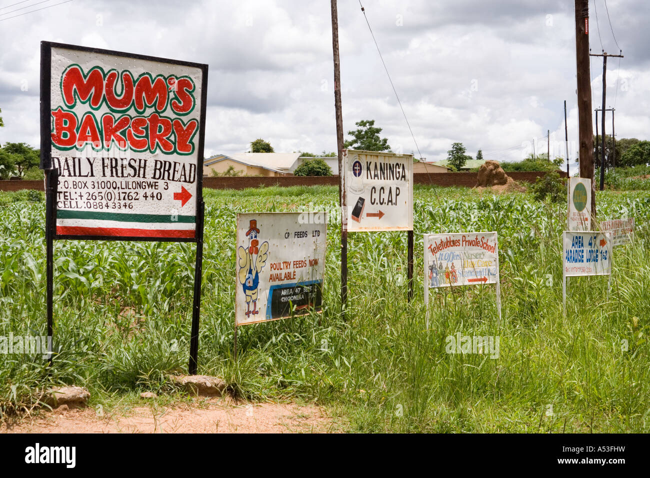 Advertising signs beside the road in Area 47 Lilongwe Malawi Africa Stock Photo