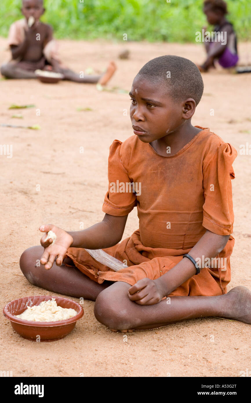 Hungry children eating phala as part of the Joseph Project feeding programme in the village of Buli, Malawi, Africa Stock Photo