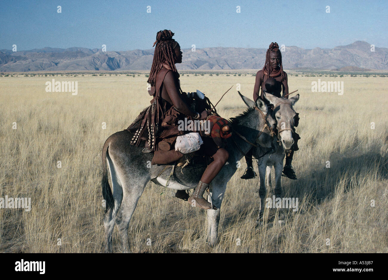 Himba Women In Traditional Leather Clothing Crossing The Marienfluss On