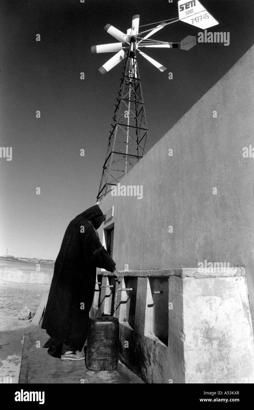Painet ha1330 130 black and white technology man collecting water pumped by wind kessarine tunisia country developing nation Stock Photo