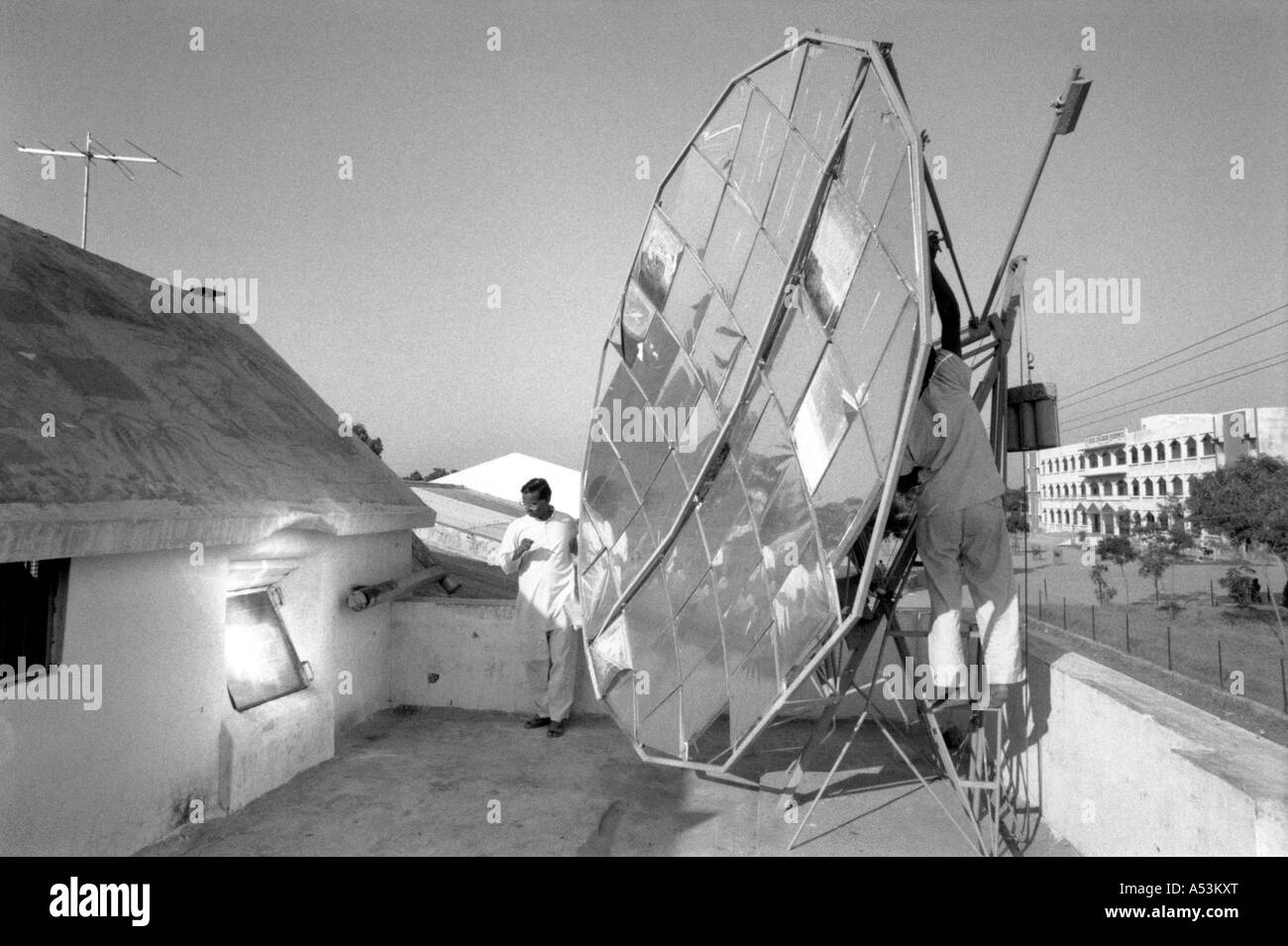 Painet ha1331 131 black and white technology parabolic dish concentrating suns rays cookingpot behind window school gujarat Stock Photo