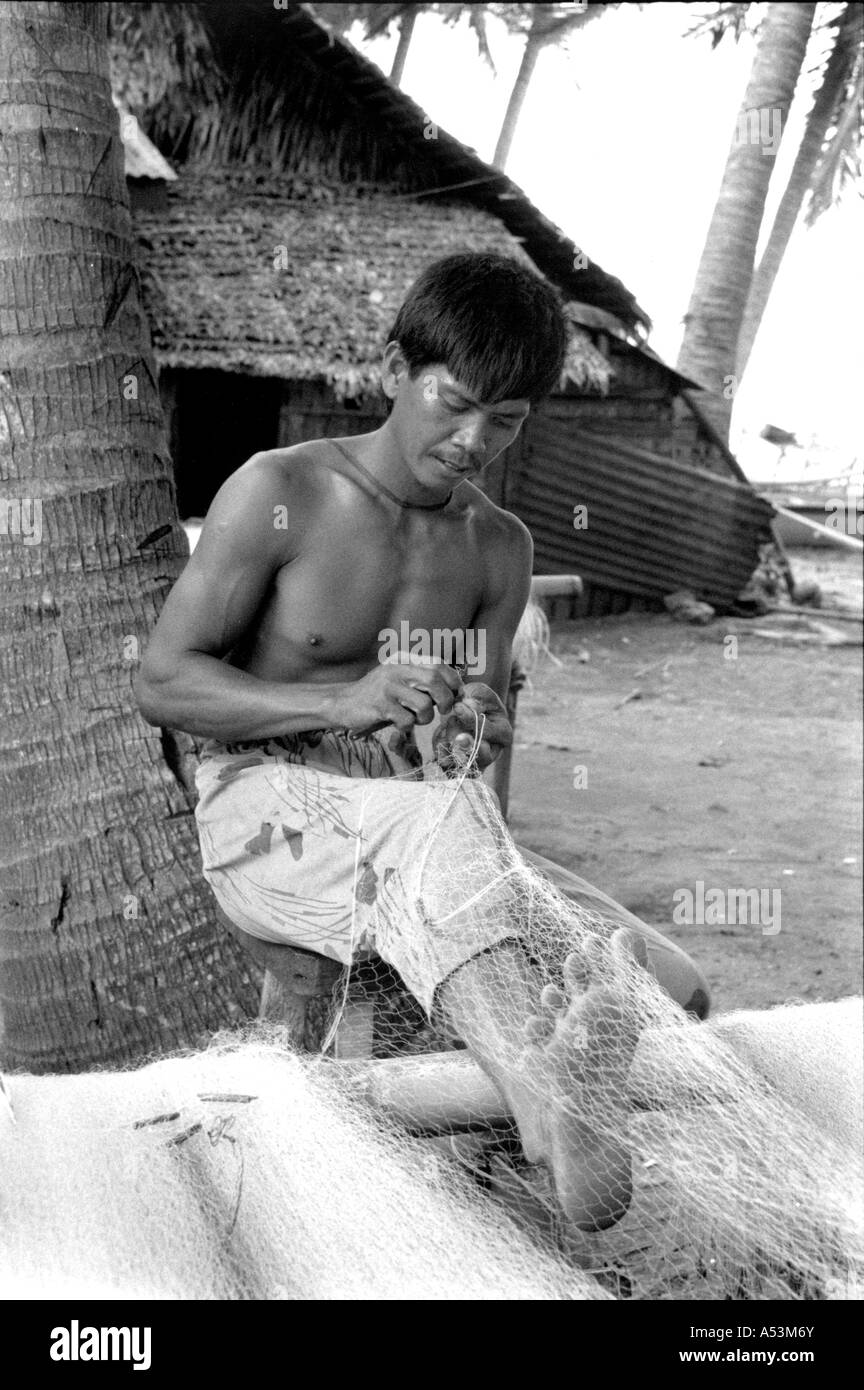 Painet ha1375 184 black and white clabor fisherman mending nets luzon philippines country developing nation less Stock Photo