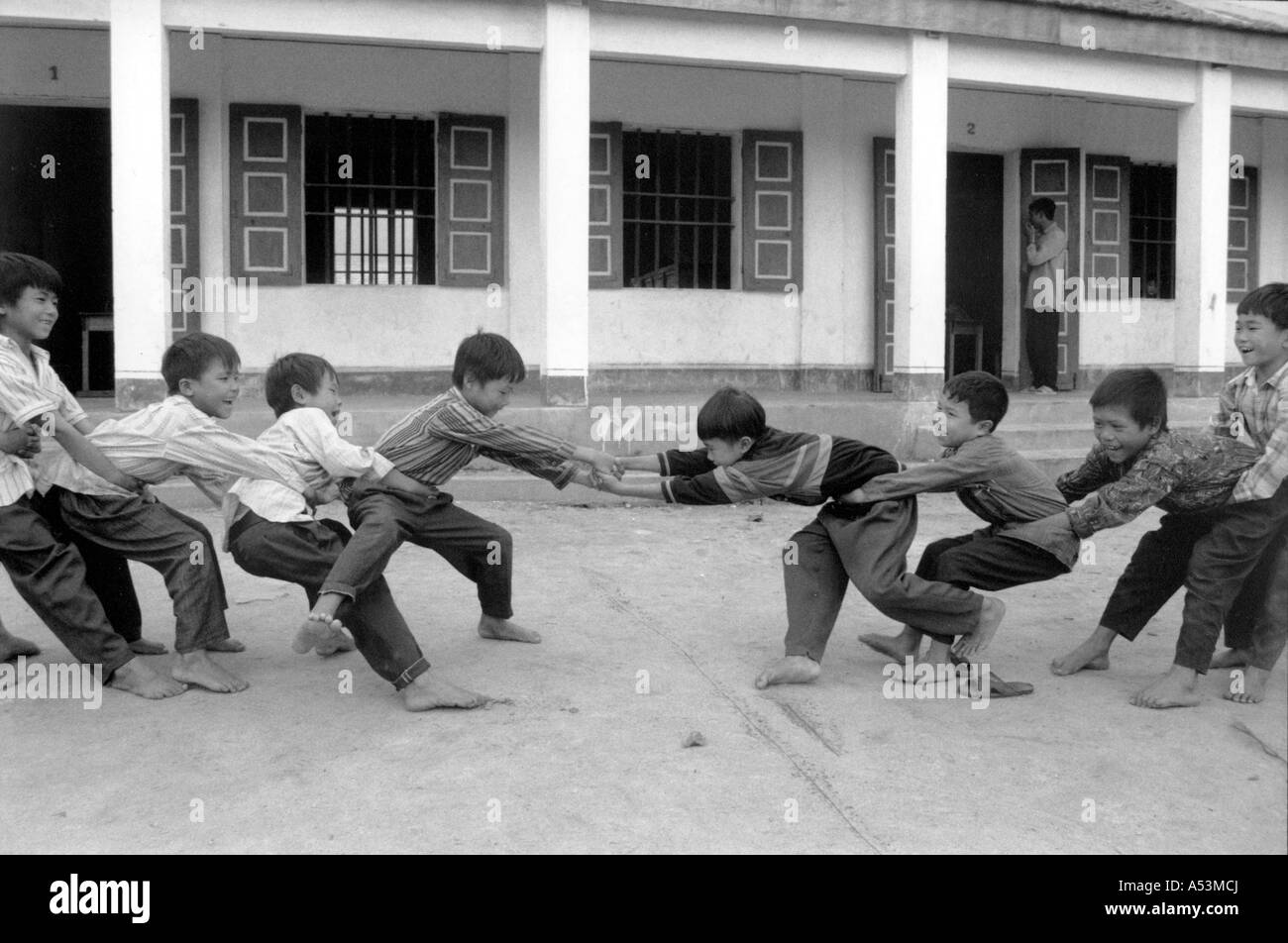 Painet ha1395 209 black and white children boys having tugowar tug-o-war tug og war games match ky anh vietnam country Stock Photo