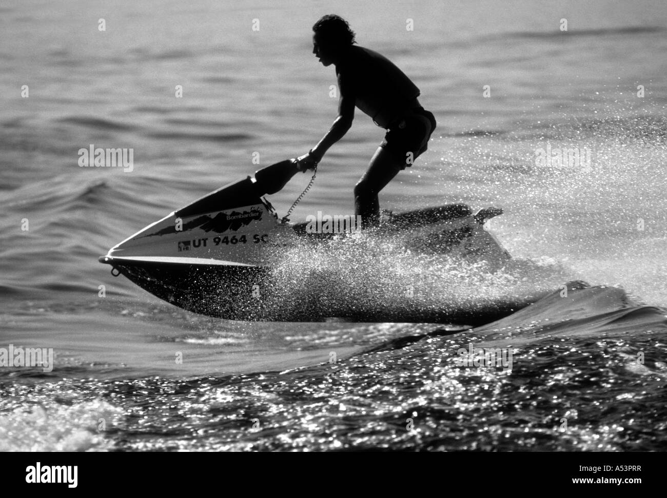 Young Man Riding A Jet Ski,On The Waters Of The Manmade, Lake Powell In Utah ,USA Stock Photo