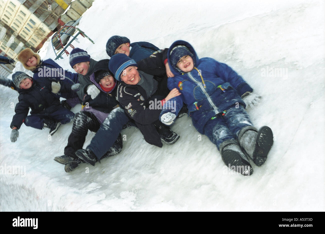 Children on a slider board Altai Siberia Russia Stock Photo