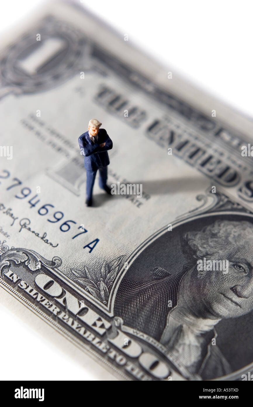 Business figurine placed on a dollar Stock Photo