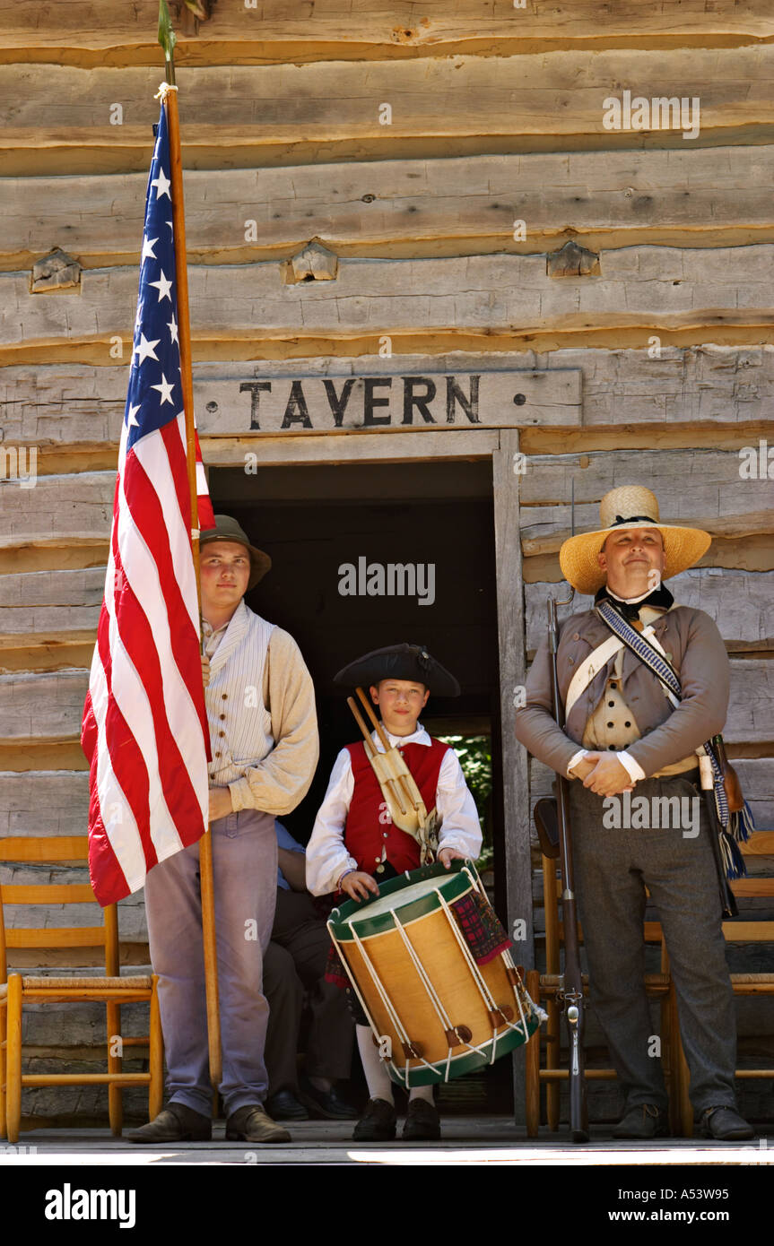 ILLINOIS New Berlin Fourth of July period costumes man hold USA flag boy drummer outside tavern door Stock Photo