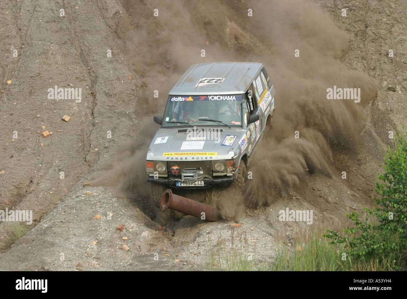 Range Rover 4x4 car dives with speed against a steel pipe or steel tube Stock Photo