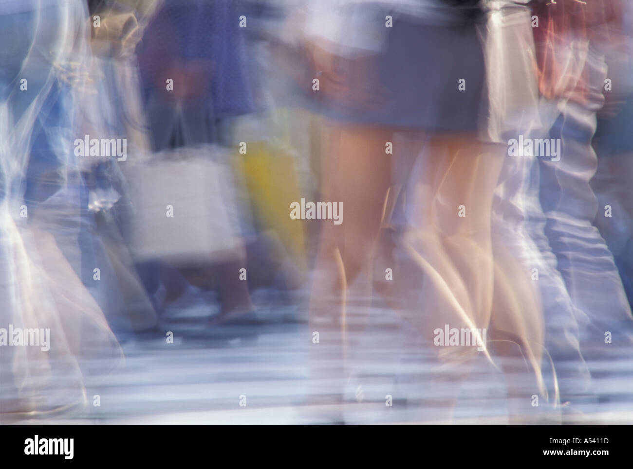 Blurred legs of people crossing street Stock Photo
