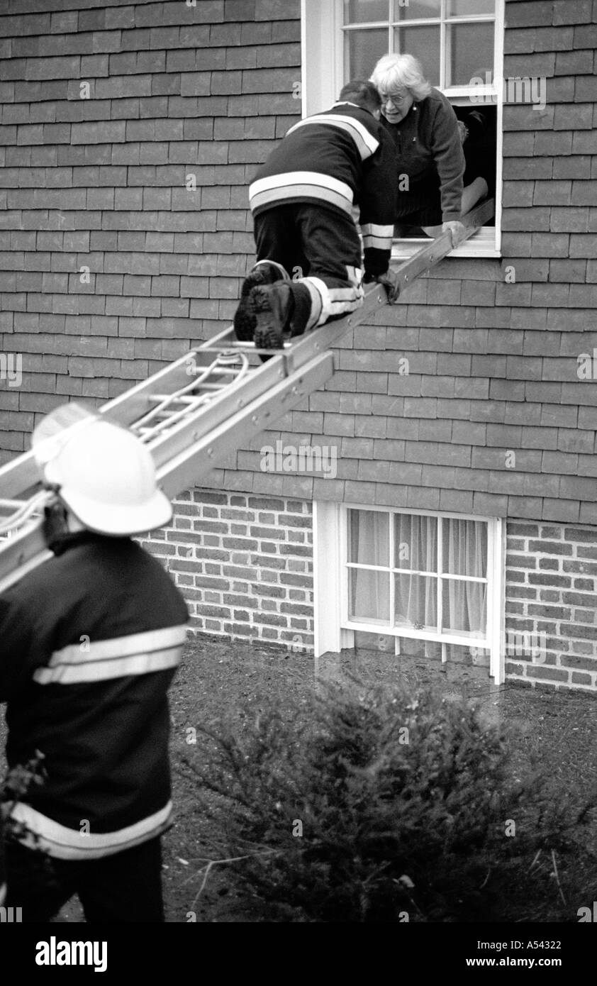 Firefighters rescuing elderly lady at Lewes floods East Sussex UK 2000 Stock Photo