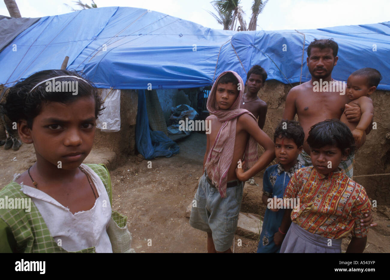 Painet ha2594 5446 father children india disasters family lost home by cyclone orissa country developing nation economically Stock Photo