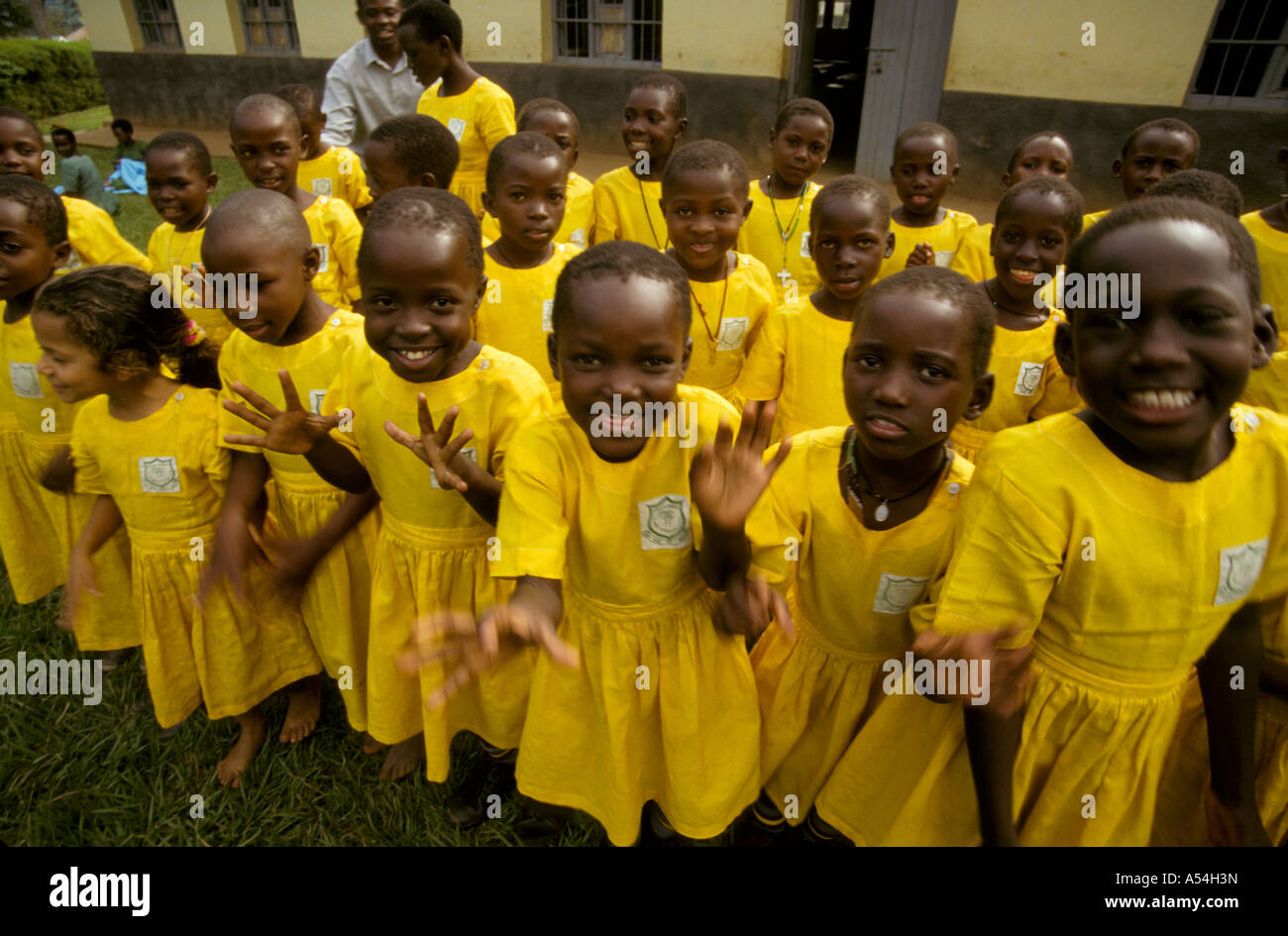 Painet hq1464 uganda primary school girls yellow uniforms singing dancing masaka children game happy images country Stock Photo