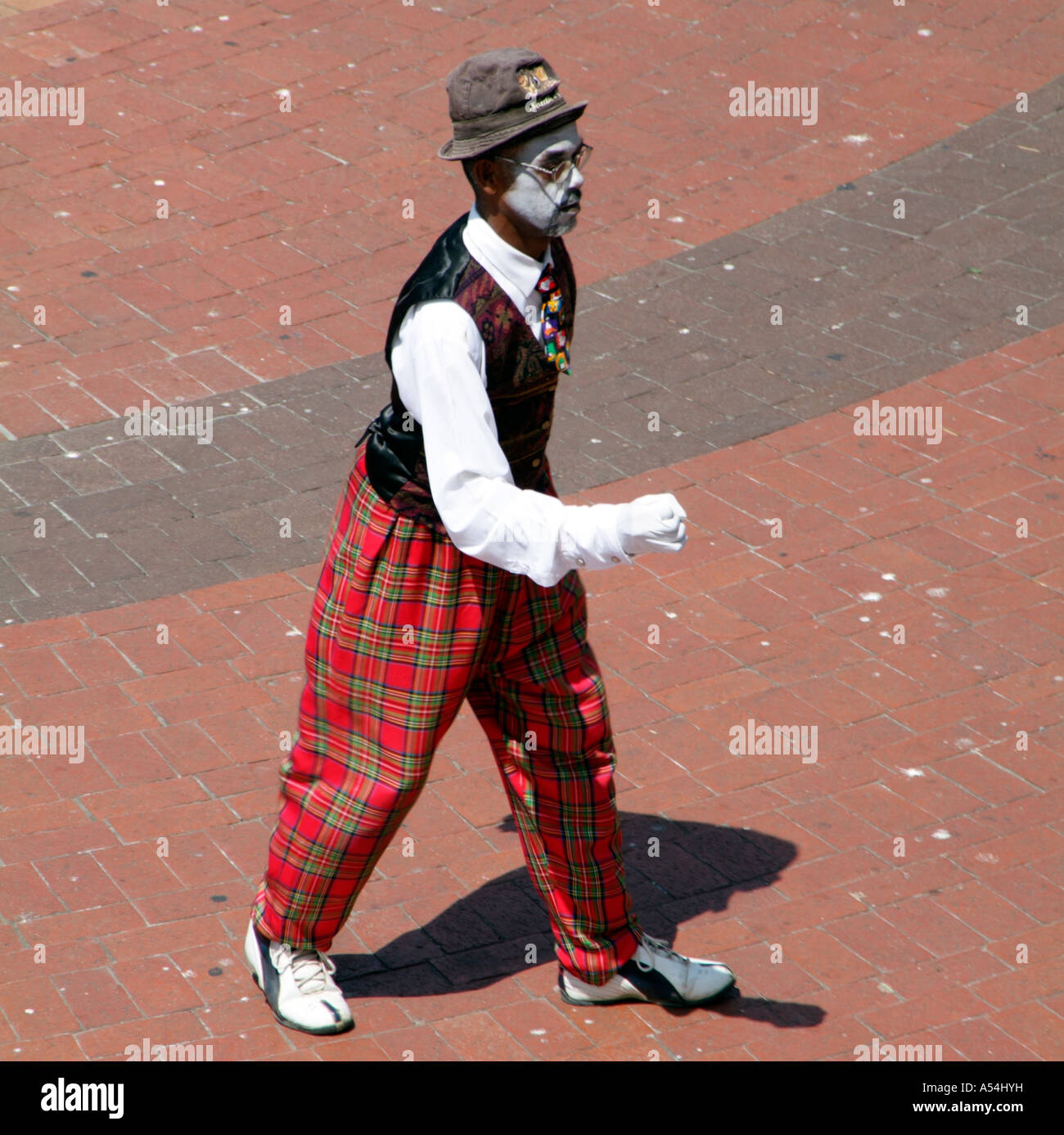 Clown with a painted face wearing tartan trousers.Entertainer.South Africa  Stock Photo - Alamy