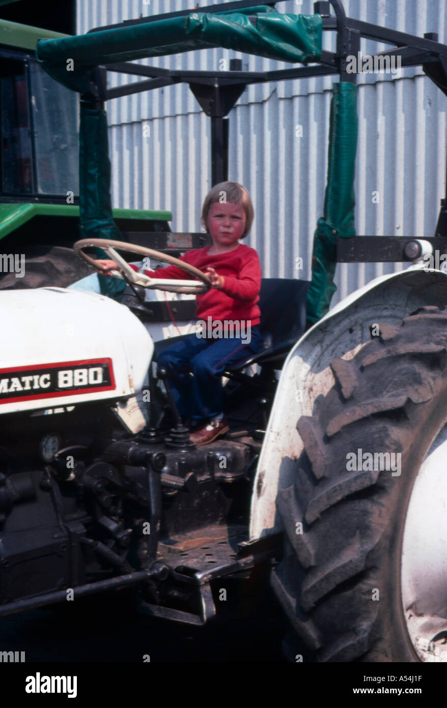 Young boy on tractor Stock Photo Alamy
