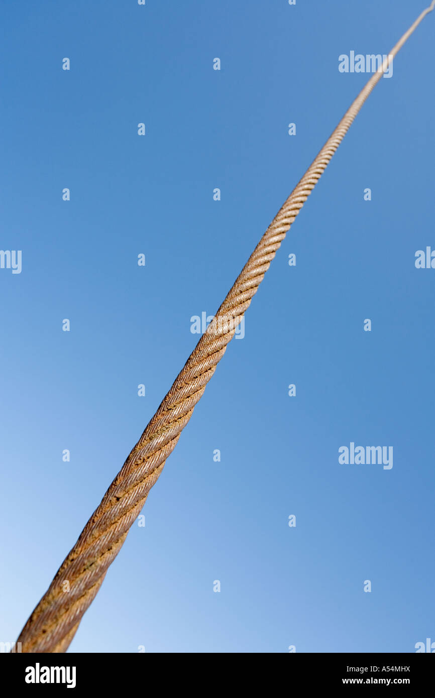Rusty steel rope against blue sky Stock Photo