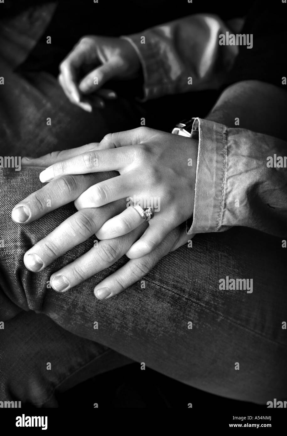 Couple is holding hands in a black and white Stock Photo - Alamy