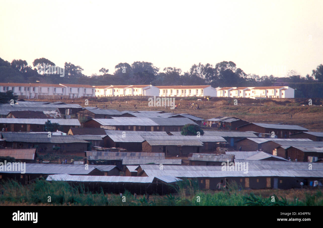 Slum housing in Kibera with modern low cost but new homes in the background Nairobi Kenya East Africa Stock Photo
