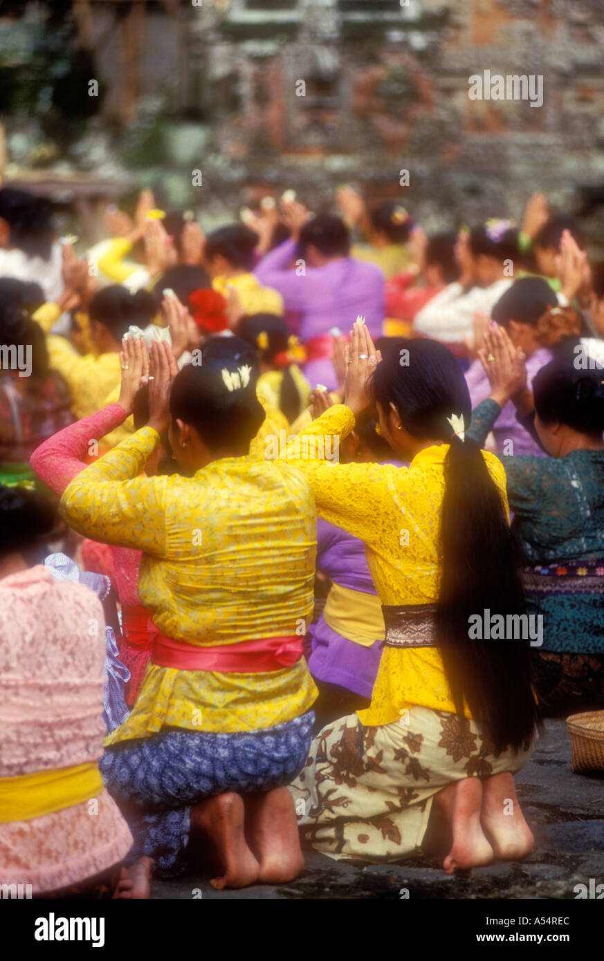 Balinese Hindu women praying at temple in Bali Indonesia Stock Photo