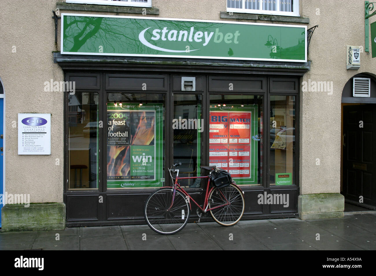 Bicycle propped up against a boomaker's window in Devizes Wiltshire Stock Photo