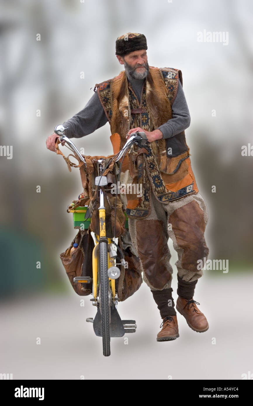 a well known local inhabitant of Giesing pushing a bicycle in Munich Bavaria Germany Europe Stock Photo