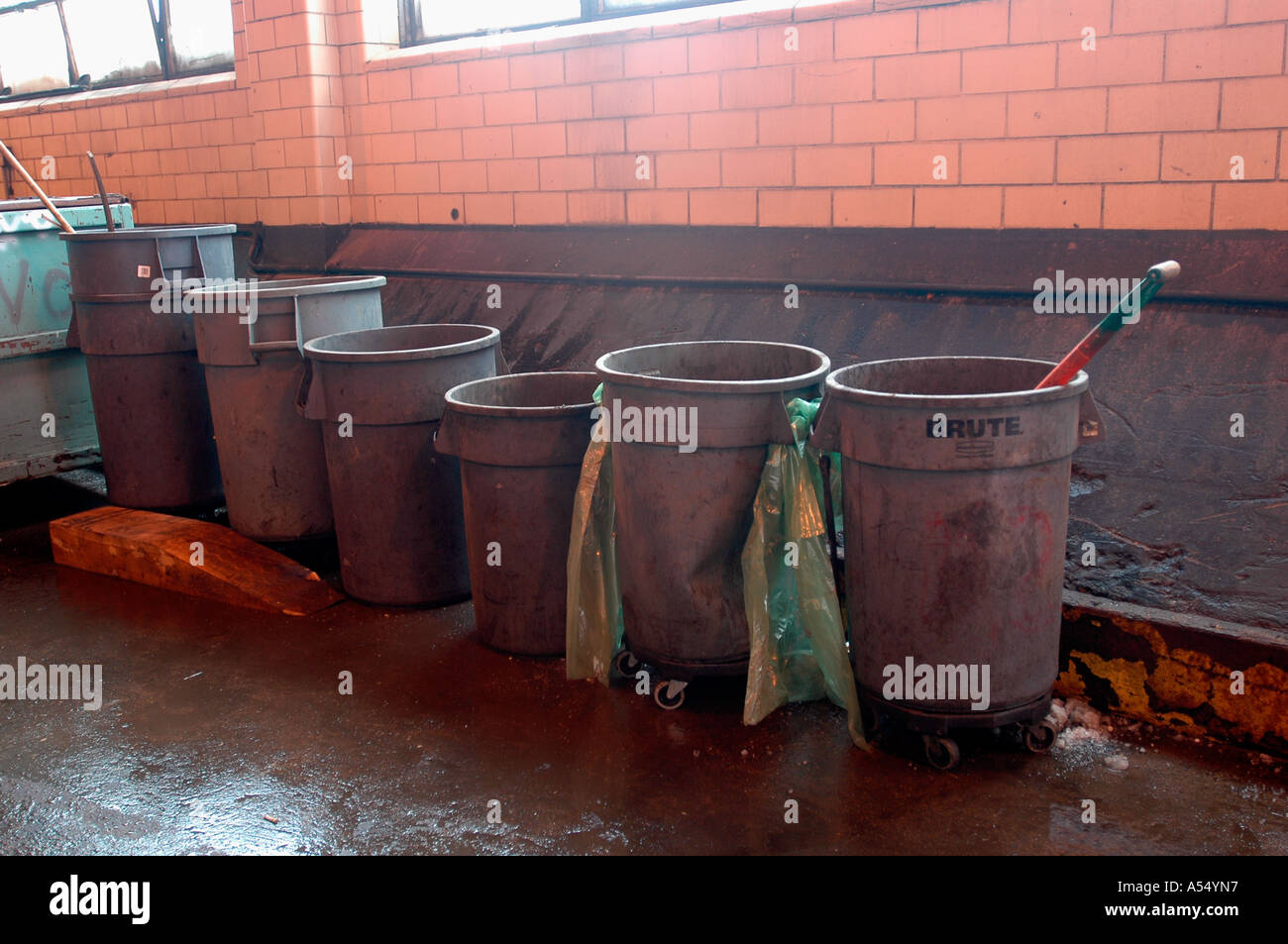 Trash cans in a sanitation garage Stock Photo Alamy