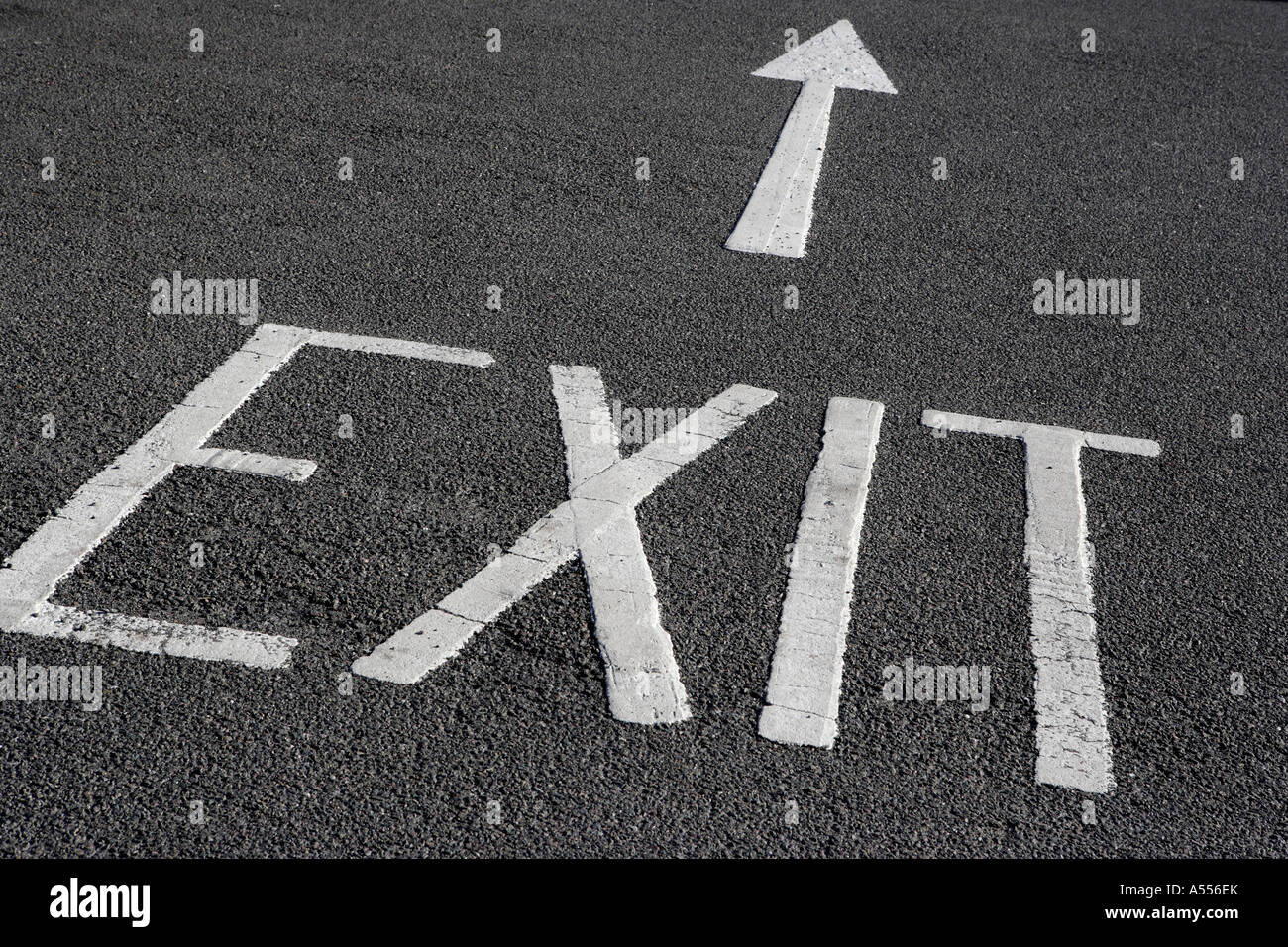 Exit sign and arrow painted on tarmac Stock Photo