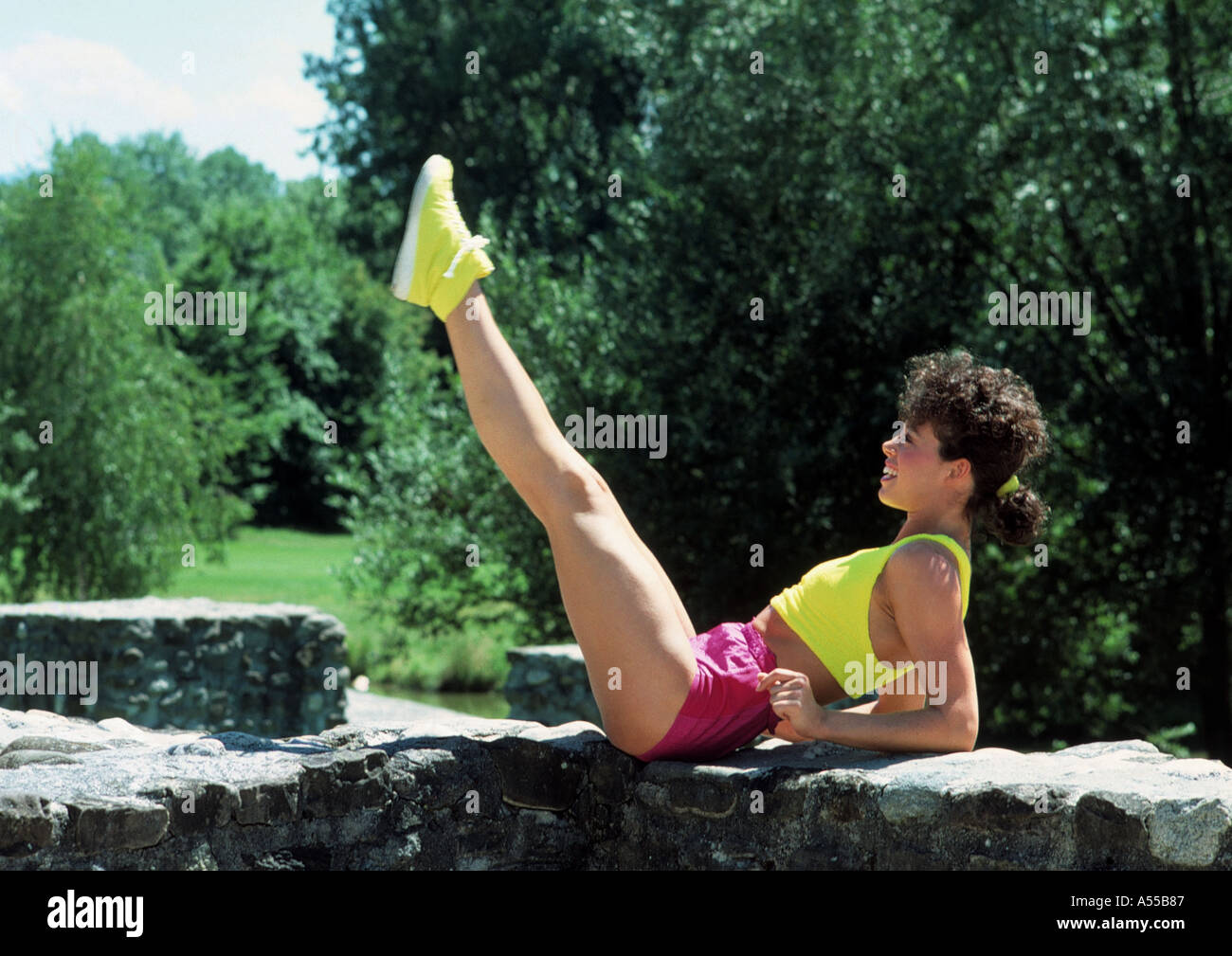 young woman doing outdoor gymnastic exercises Stock Photo