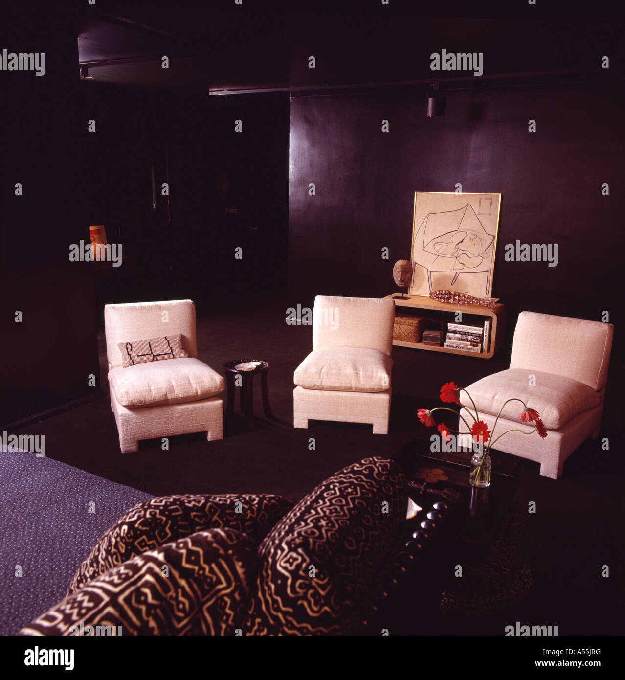 Cream leather upholstered chairs in black eighties living room Stock