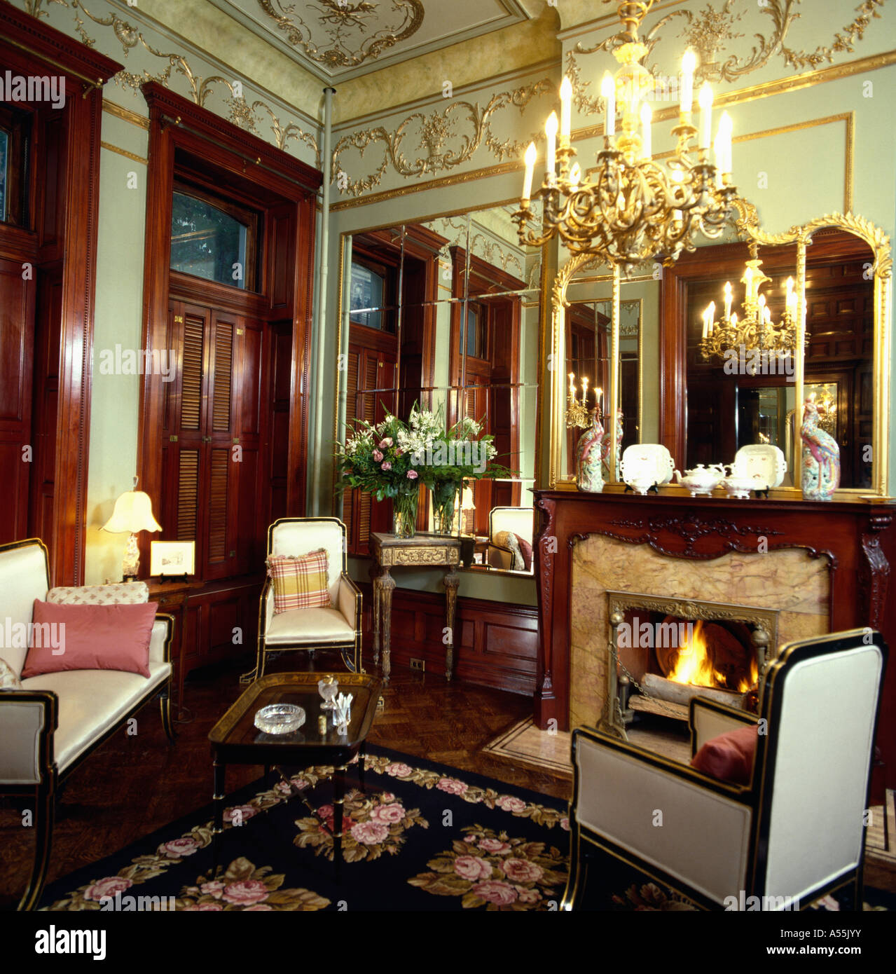 Ornate chandelier in drawing room in French chateau with gilded cornice