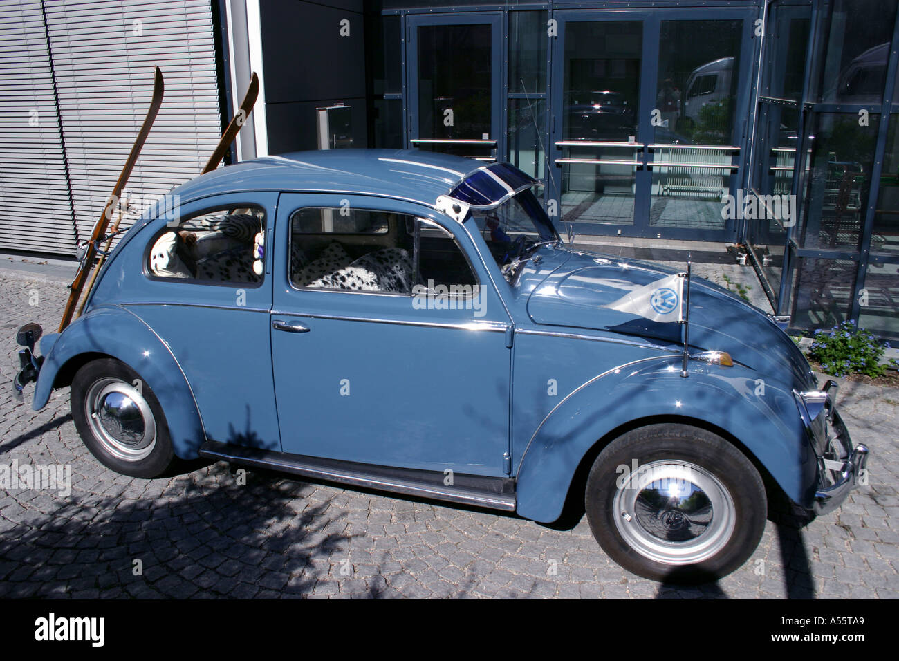 A Volkswagen 1959 beetle car with oldfashioned snow ski seen in Munich Bavaria Germany Stock Photo