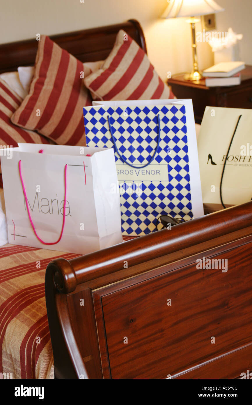 shopping bags on hotel bed Stock Photo Alamy