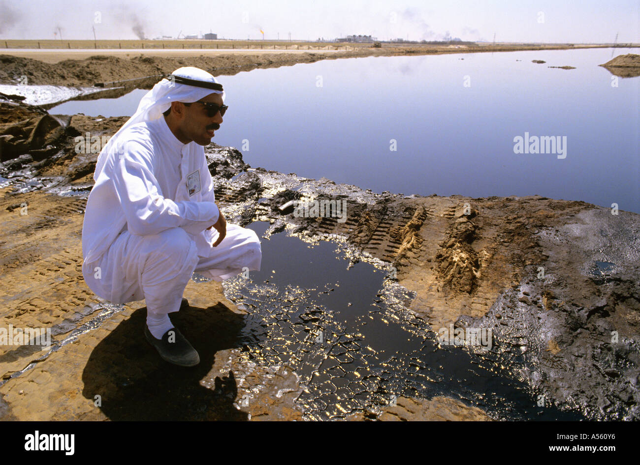 Arab male Oil worker checks Kuwait oil lake Stock Photo