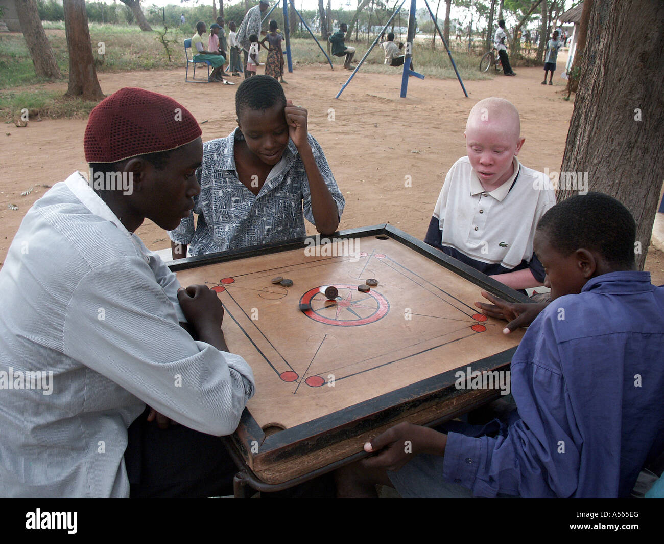 Painet iy7591 tanzania boys playing board game musoma one boy african albino country developing nation less economically Stock Photo