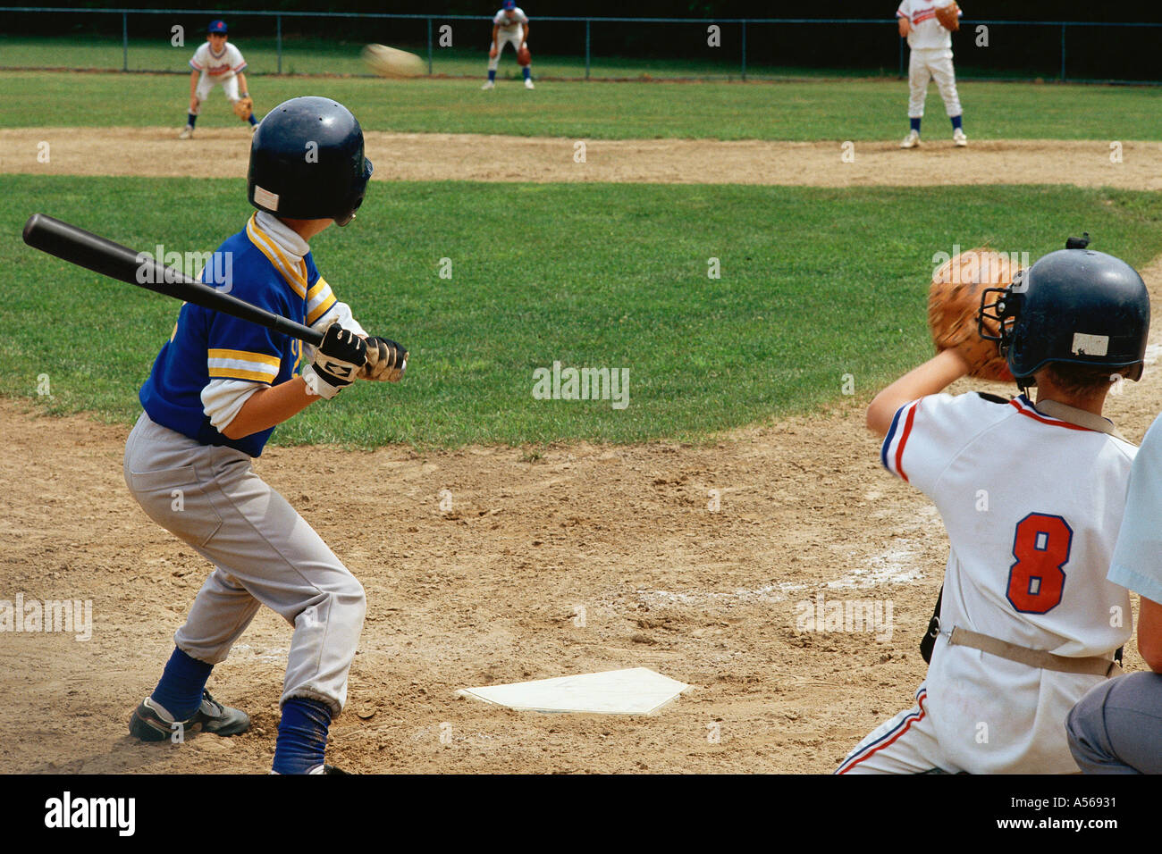 Young batter preparing to hit baseball Stock Photo