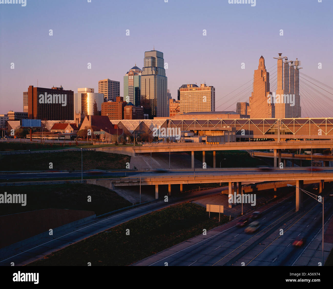 Freeway with city beyond in early morning Stock Photo