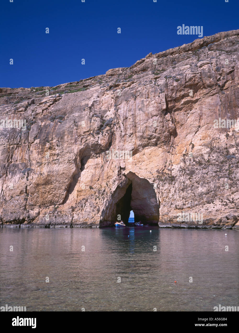 Tourist boats in the natural tunnel which connects the Inland Sea Il Qawra to the Mediterranean Dwejra Point Gozo Malta Stock Photo