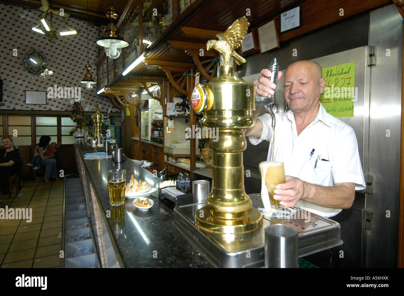 Barman pulling a litre of larger in  Tasca Angel Tapas bar in old town Valencia Stock Photo