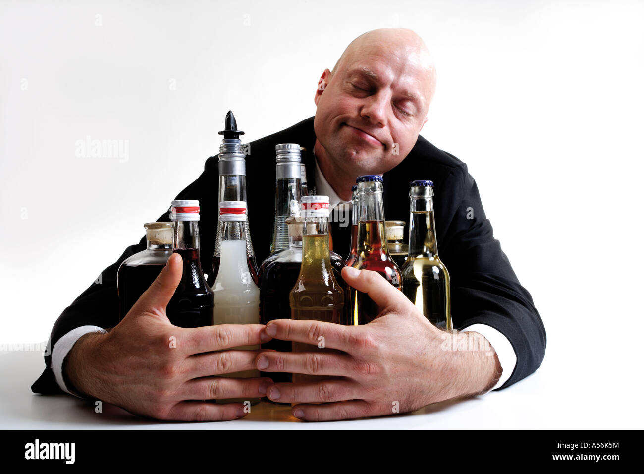 Man hugging alkohol bottles Stock Photo