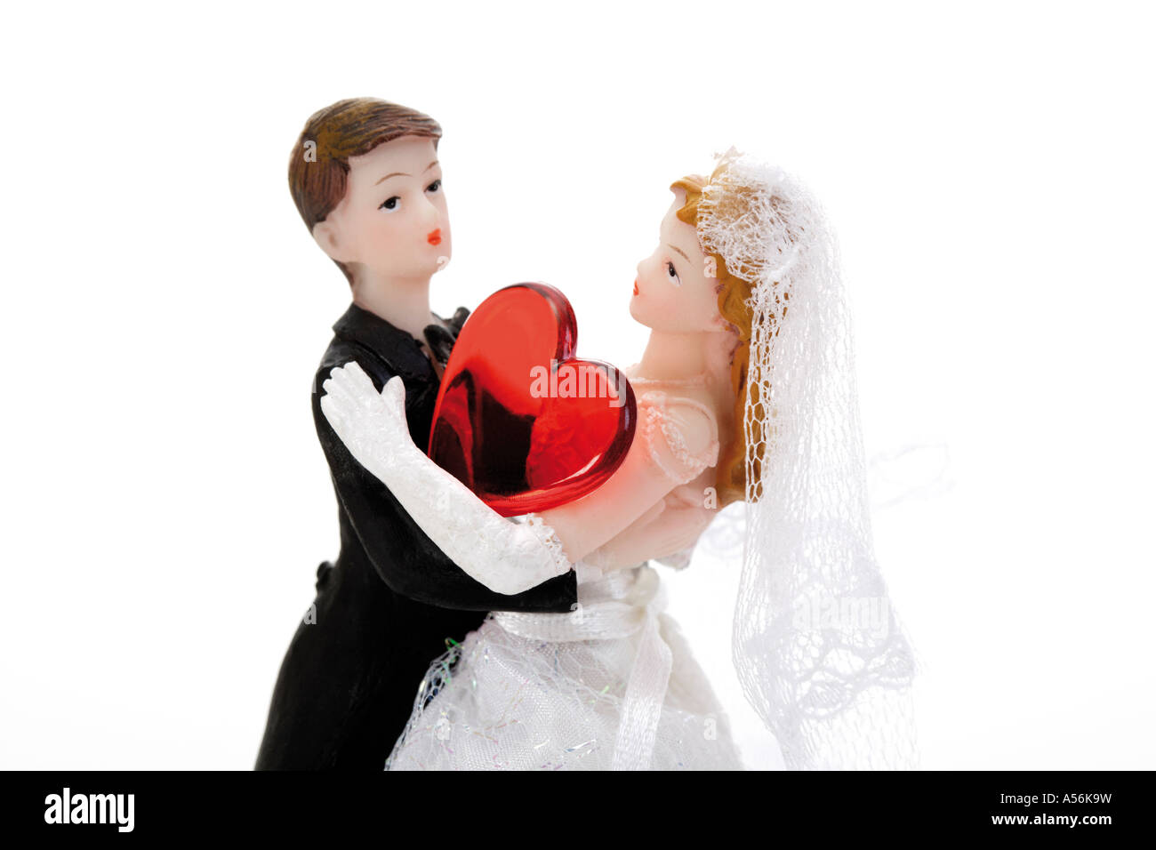 Wedding couple figurines with red heart, close-up Stock Photo - Alamy