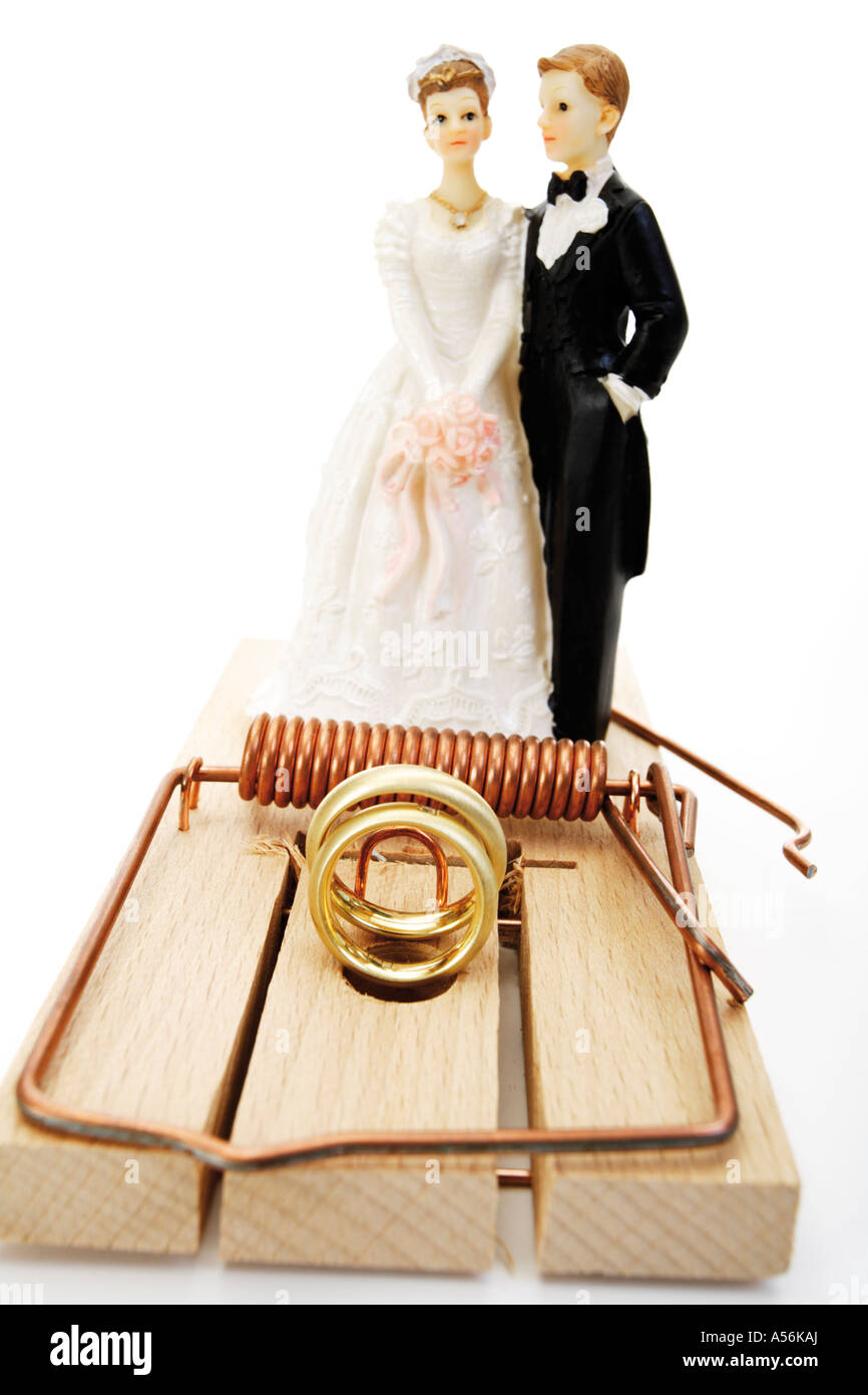 Wedding couple standing behind mouse trap, close-up Stock Photo