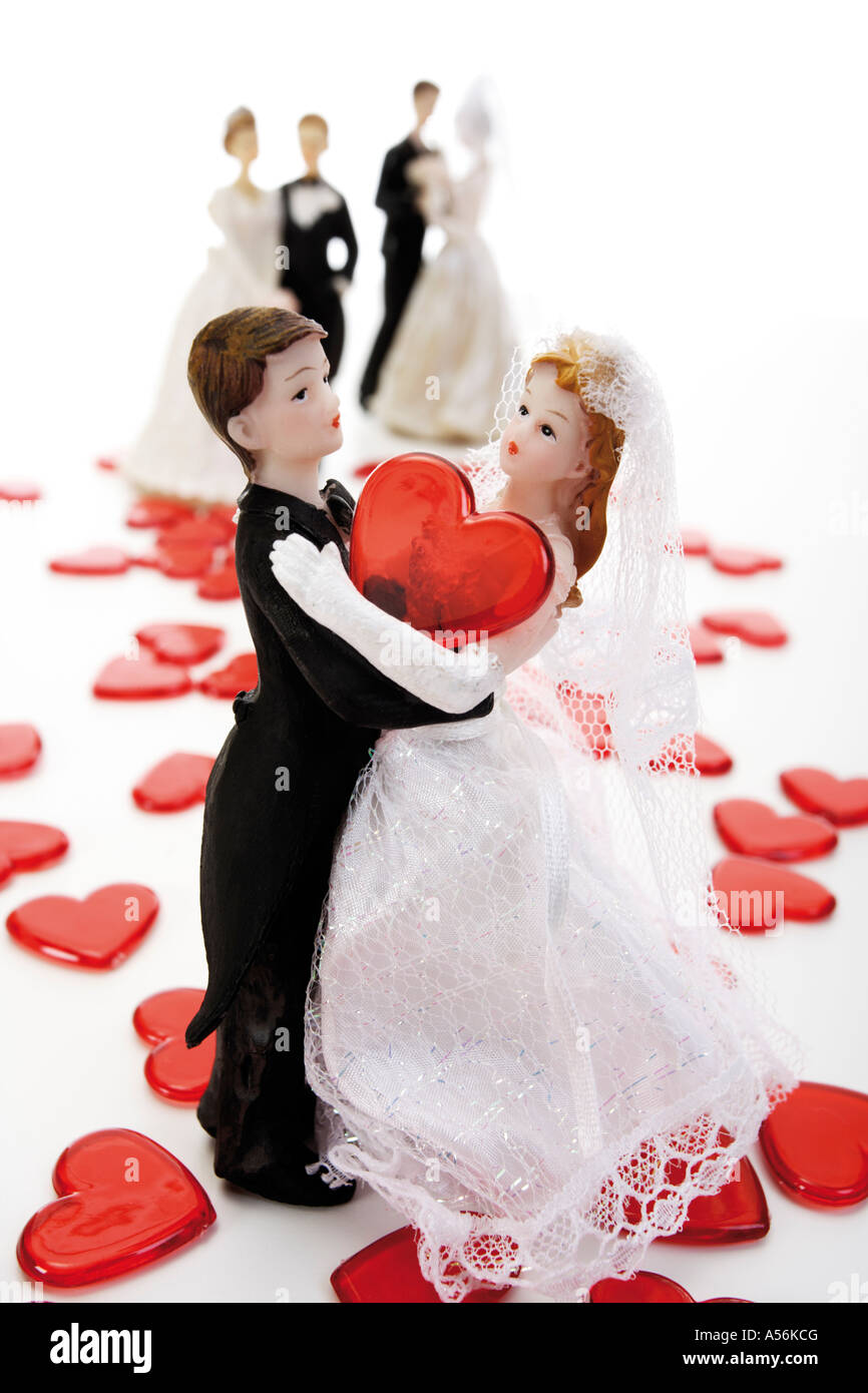 Wedding couple figurines on red hearts, close-up Stock Photo - Alamy